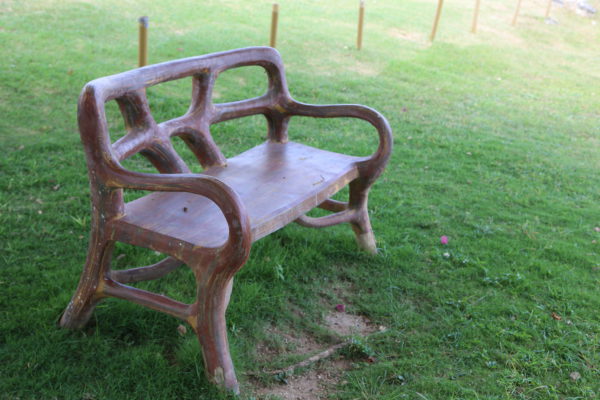Sit a spell and relax on this carved wooden bench.